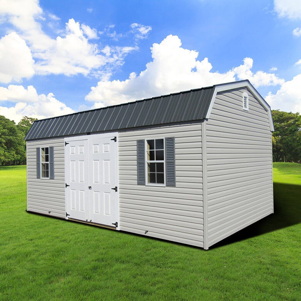 Gray gambrel loft style shed with dark roof and windows