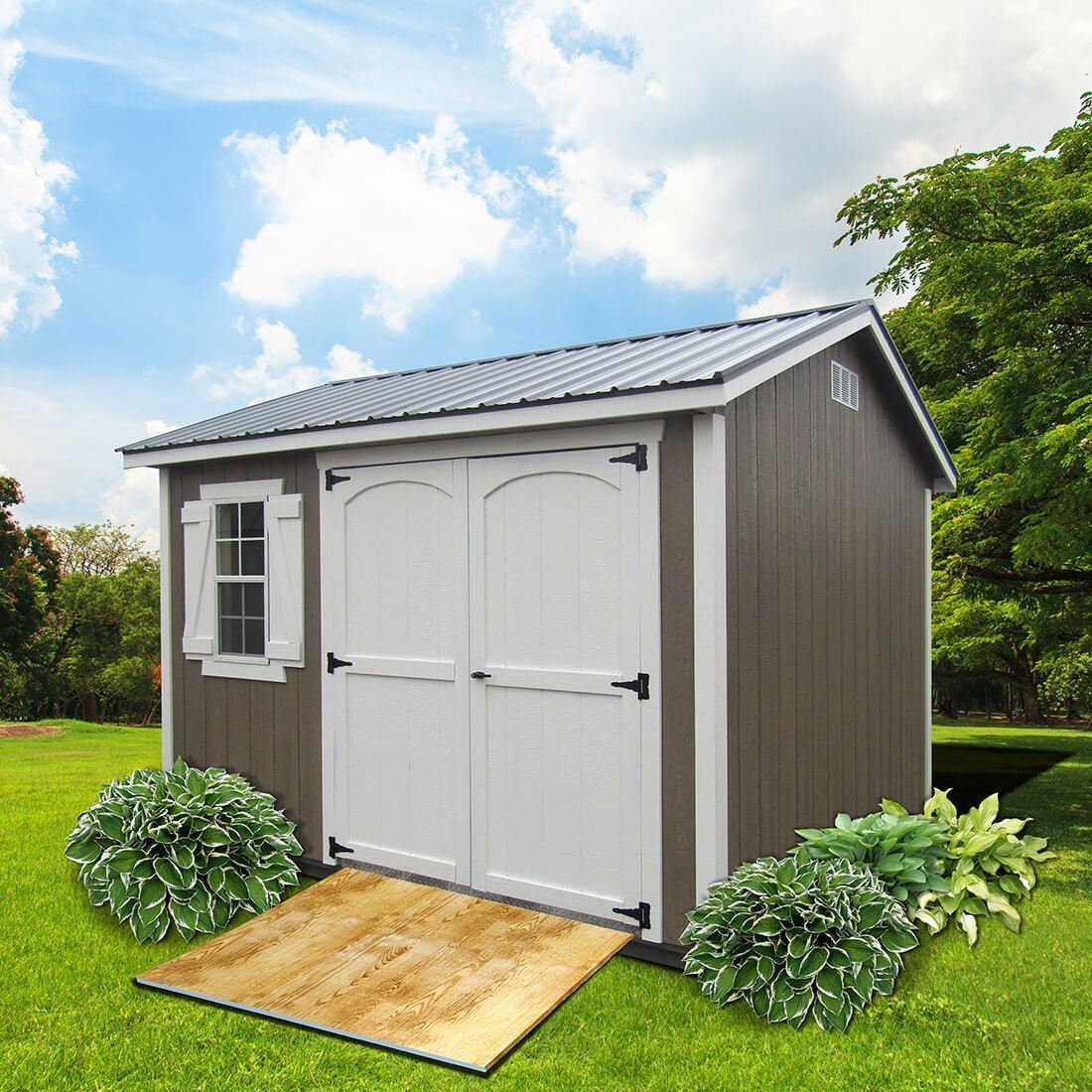 Brown cape cod style shed with white trim and doors
