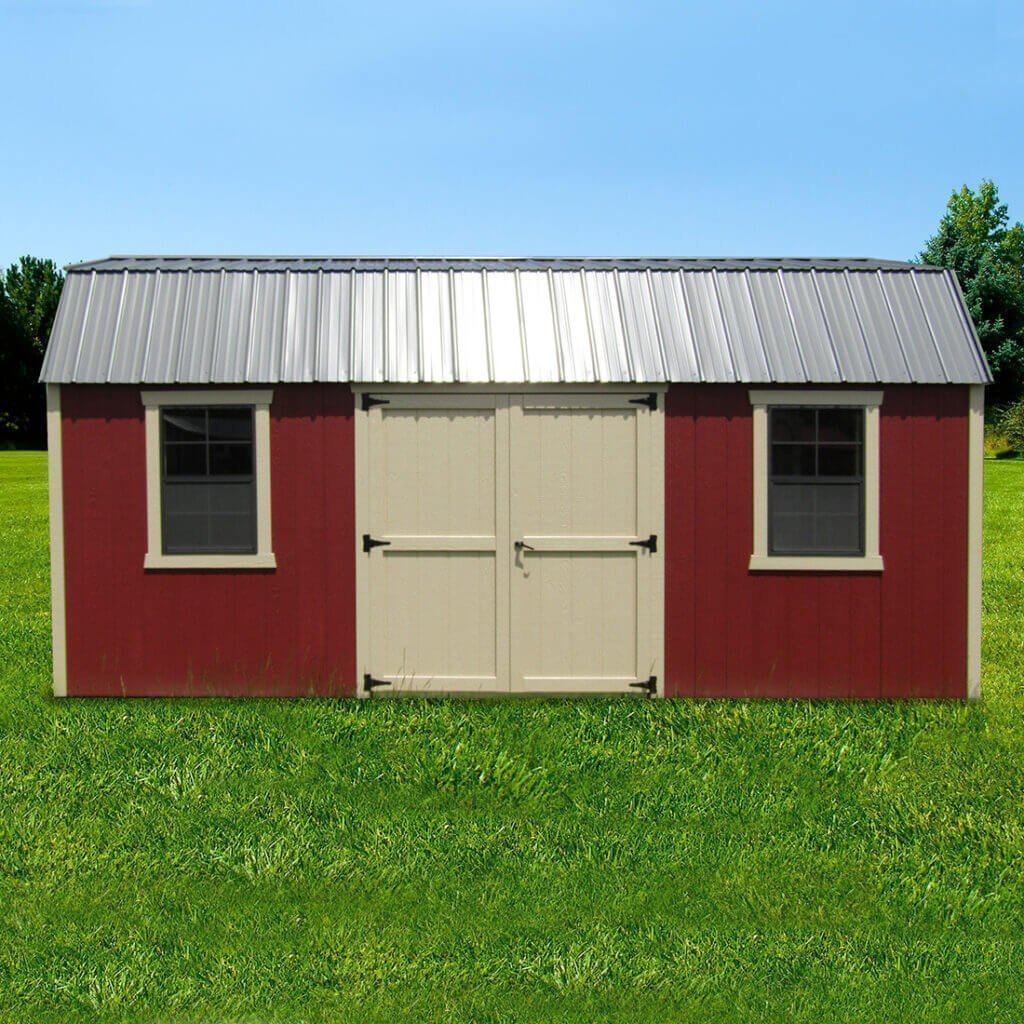 Red new England dutch barn shed with tan trim and doors