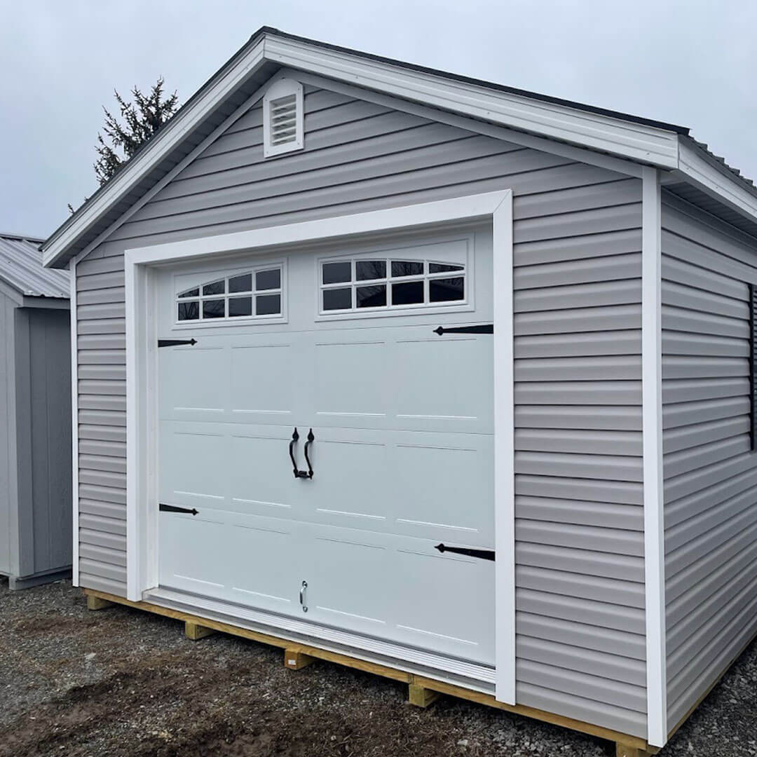 Gray gable garage with white trim and doors