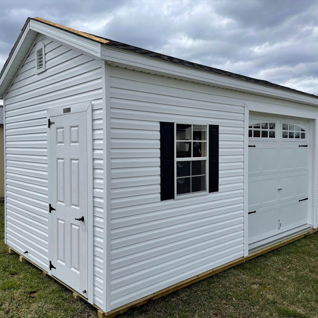 White gable garage with black shutters